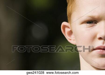 Stock Photo - Portrait of a boy looking serious. Fotosearch