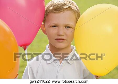 Stock Image - Portrait of a boy with balloons. Fotosearch