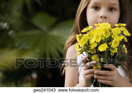 Portrait of a girl holding a bunch of flowers View Large Photo Image Stock Image - Portrait of a girl holding a bunch of flowers. Fotosearch