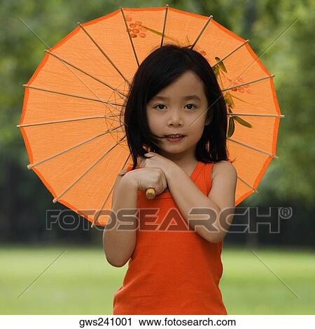 Stock Image - Portrait of a girl holding a parasol. Fotosearch