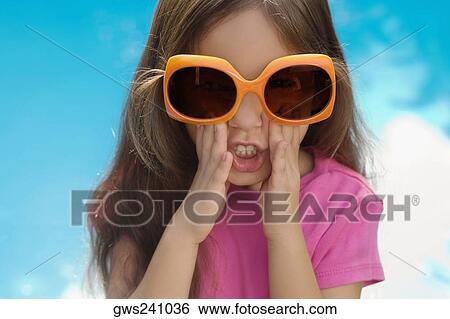 Portrait of a girl wearing sunglasses View Large Photo Image Stock Photograph - Portrait of a girl wearing sunglasses. Fotosearch