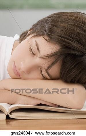 Stock Photo - Close-up of a schoolboy sleeping on a desk in a classroom. Fotosearch