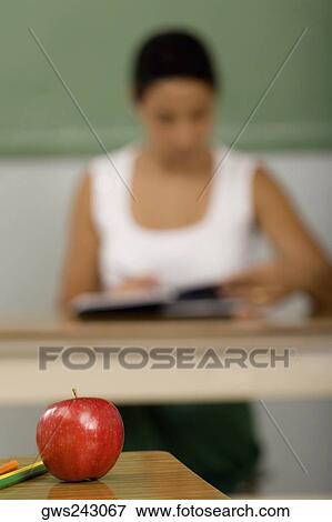 Close-up of an apple on a desk View Large Photo Image Stock Photo - Close-up of an apple on a desk. Fotosearch