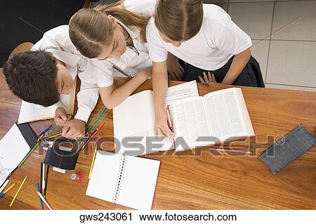 High angle view of two schoolgirls and a schoolboy studying together in a classroom View Large Photo Image Stock Image - High angle view of two schoolgirls and a schoolboy studying together in a classroom. Fotosearch