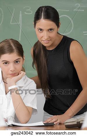 Portrait of a female teacher with a schoolgirl in a classroom View Large Photo Image Stock Image - Portrait of a female teacher with a schoolgirl in a classroom. Fotosearch