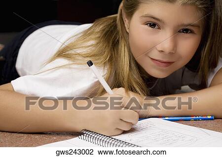 Portrait of a girl writing on a textbook with a pencil View Large Photo Image Stock Image - Portrait of a girl writing on a textbook with a pencil. Fotosearch