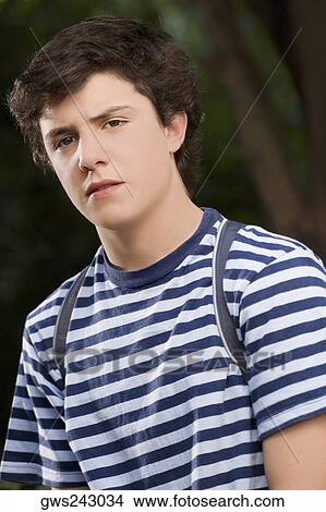 Portrait of a schoolboy looking serious View Large Photo Image Picture - Portrait of a schoolboy looking serious. Fotosearch