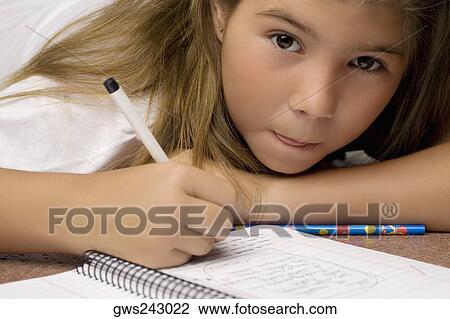 Portrait of a schoolgirl writing on a textbook with a pencil View Large Photo Image Stock Image - Portrait of a schoolgirl writing on a textbook with a pencil. Fotosearch