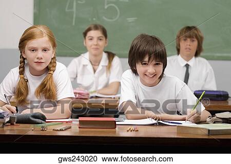 Portrait of four school students sitting in a classroom View Large Photo Image Stock Image - Portrait of four school students sitting in a classroom. Fotosearch