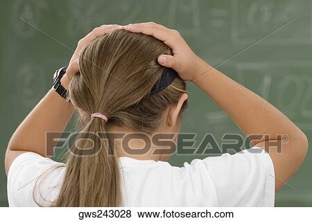 Rear view of a schoolgirl with her hands in her hair View Large Photo Image Stock Photo - Rear view of a schoolgirl with her hands in her hair. Fotosearch