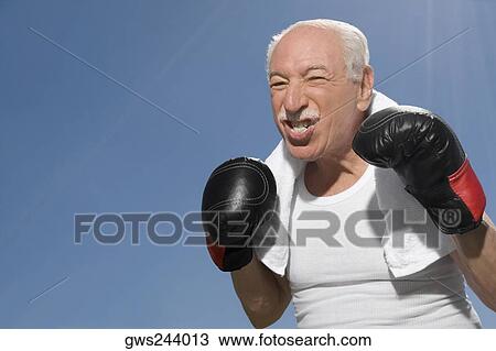 Close-up of a senior man in boxing pose View Large Photo Image Stock Image - Close-up of a senior man in boxing pose. Fotosearch