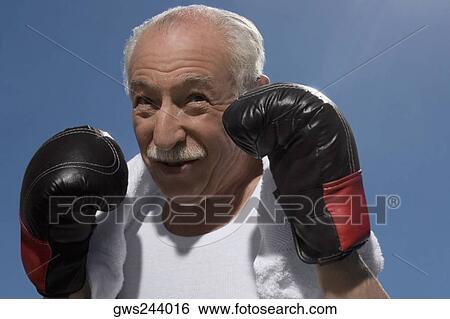 Close-up of a senior man in boxing pose View Large Photo Image Stock Photograph - Close-up of a senior man in boxing pose. Fotosearch