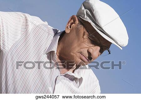 Close-up of a senior man wearing a flat cap View Large Photo Image Stock Photo - Close-up of a senior man wearing a flat cap. Fotosearch