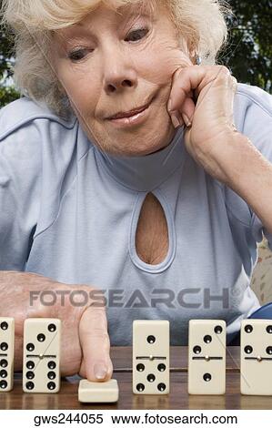 Stock Photography - Close-up of a senior woman playing dice. Fotosearch