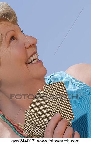 Close-up of a senior woman playing cards and smiling View Large Photo Image Stock Photo - Close-up of a senior woman playing cards and smiling. Fotosearch
