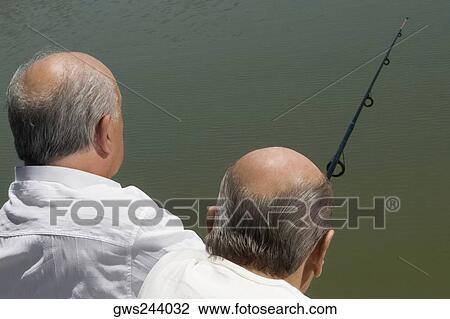Rear view of two senior men fishing View Large Photo Image Stock Image - Rear view of two senior men fishing. Fotosearch