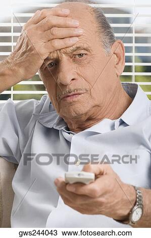Senior man operating a remote control View Large Photo Image Stock Image - Senior man operating a remote control. Fotosearch