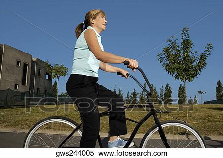 Side profile of a senior woman cycling View Large Photo Image Stock Photography - Side profile of a senior woman cycling. Fotosearch