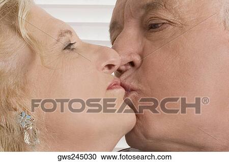Close-up of a senior man kissing a senior woman View Large Photo Image Stock Image - Close-up of a senior man kissing a senior woman. Fotosearch