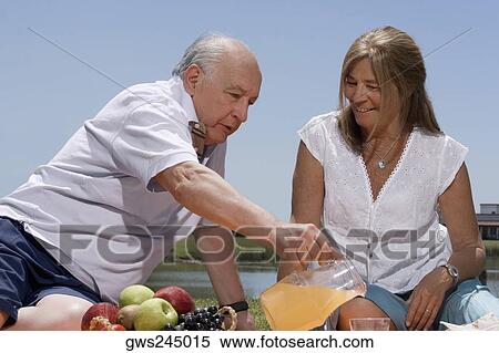 Stock Photography - Senior couple at picnic. Fotosearch