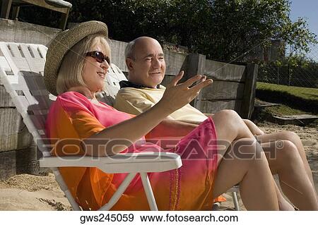 Stock Photo - Senior couple sitting on chairs. Fotosearch