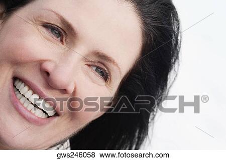 Close-up of a mature woman smiling View Large Photo Image Stock Photo - Close-up of a mature woman smiling. Fotosearch