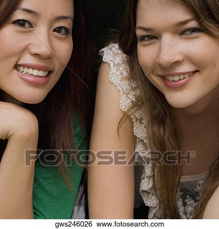 Portrait of two young women smiling together View Large Photo Image Stock Photograph - Portrait of two young women smiling together. Fotosearch