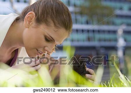 Young couple romancing in a park View Large Photo Image Stock Image - Young couple romancing in a park. Fotosearch