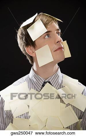Businessman covering with adhesive notes and thinking View Large Photo Image Stock Photo - Businessman covering with adhesive notes and thinking. Fotosearch