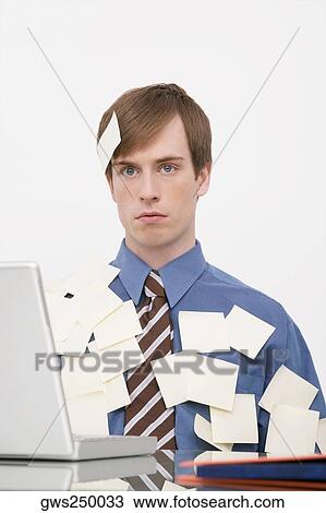 Businessman working on a laptop and covering with adhesive notes View Large Photo Image Stock Image - Businessman working on a laptop and covering with adhesive notes. Fotosearch