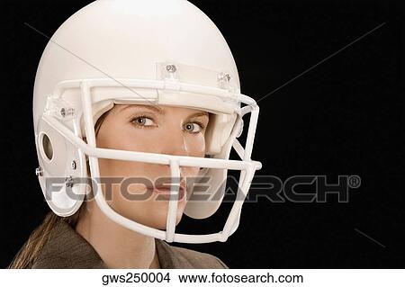 Close-up of a businesswoman wearing a football helmet View Large Photo Image Picture - Close-up of a businesswoman wearing a football helmet. Fotosearch