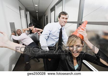 Office workers playing in an office View Large Photo Image Stock Photo - Office workers playing in an office. Fotosearch