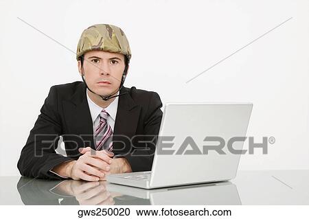 Portrait of a businessman wearing an army helmet View Large Photo Image Stock Image - Portrait of a businessman wearing an army helmet. Fotosearch