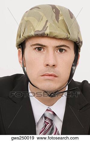 Portrait of a businessman wearing an army helmet View Large Photo Image Stock Photo - Portrait of a businessman wearing an army helmet. Fotosearch