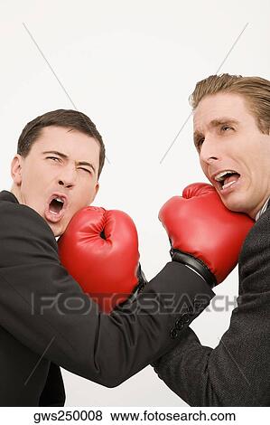 Side profile of two businessmen boxing View Large Photo Image Stock Photo - Side profile of two businessmen boxing. Fotosearch