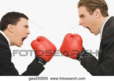 Stock Photography - Side profile of two businessmen boxing. Fotosearch
