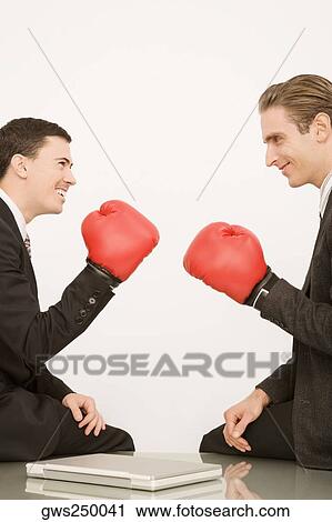 Side profile of two businessmen wearing boxing gloves View Large Photo Image Stock Image - Side profile of two businessmen wearing boxing gloves. Fotosearch