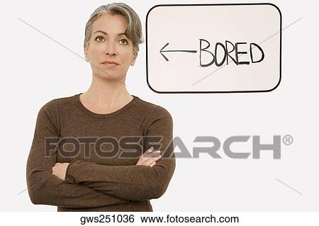Stock Photograph - Businesswoman standing with her arms crossed and thinking. Fotosearch