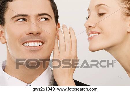 Close-up of a businesswoman whispering to a businessman View Large Photo Image Stock Photo - Close-up of a businesswoman whispering to a businessman. Fotosearch