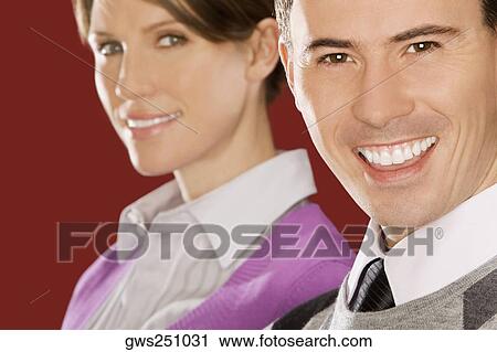 Portrait of a businessman smiling with a businesswoman behind him View Large Photo Image Stock Image - Portrait of a businessman smiling with a businesswoman behind him. Fotosearch