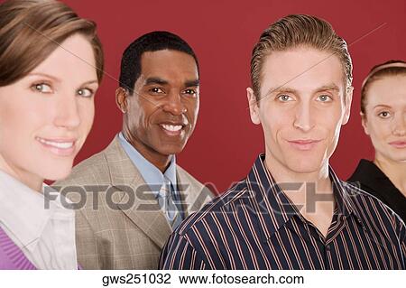 Stock Image - Portrait of four business executives smiling. Fotosearch