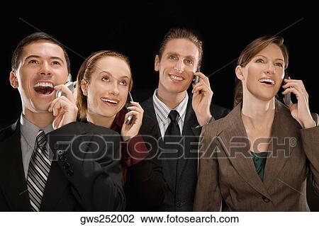 Business executives talking on mobile phones and smiling View Large Photo Image Stock Image - Business executives talking on mobile phones and smiling. Fotosearch