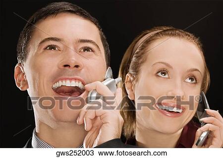 Business executives talking on mobile phones and smiling View Large Photo Image Stock Image - Business executives talking on mobile phones and smiling. Fotosearch