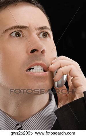 Close-up of a businessman shouting on a mobile phone View Large Photo Image Stock Photography - Close-up of a businessman shouting on a mobile phone. Fotosearch