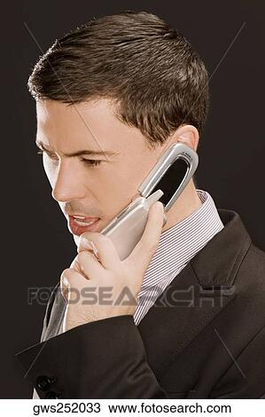 Close-up of a businessman talking on a mobile phone View Large Photo Image Stock Image - Close-up of a businessman talking on a mobile phone. Fotosearch