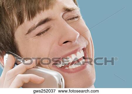 Stock Photo - Close-up of a businessman talking on a mobile phone. Fotosearch