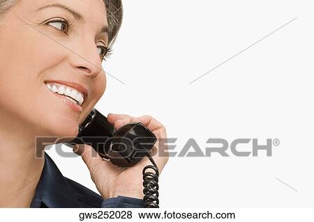 Close-up of a businesswoman talking on the telephone View Large Photo Image Stock Photo - Close-up of a businesswoman talking on the telephone. Fotosearch