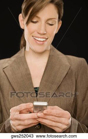 Close-up of a businesswoman text messaging View Large Photo Image Stock Image - Close-up of a businesswoman text messaging. Fotosearch