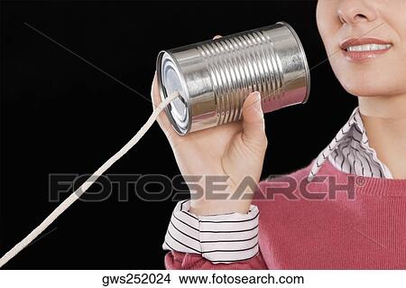 Close-up of a businesswoman using a tin can phone View Large Photo Image Picture - Close-up of a businesswoman using a tin can phone. Fotosearch