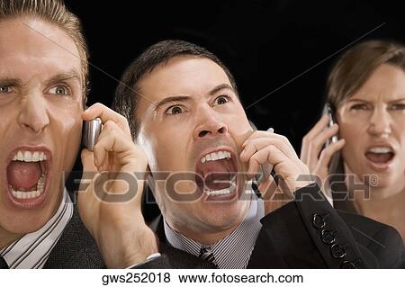 Close-up of business executives shouting on a mobile phone View Large Photo Image Stock Photo - Close-up of business executives shouting on a mobile phone. Fotosearch